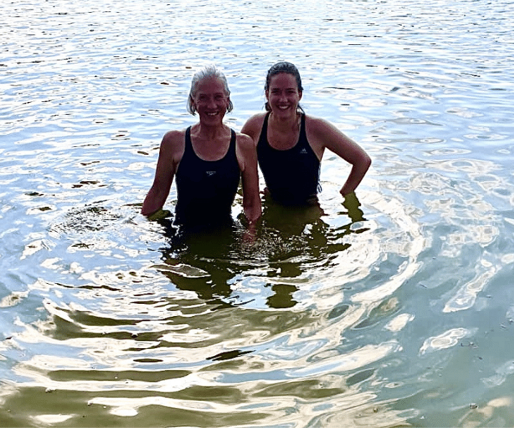 two lady swimmers in a lake