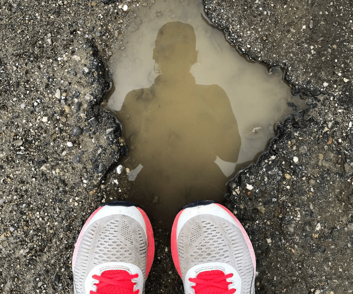 shadow of a runner or jogger in a pool of water