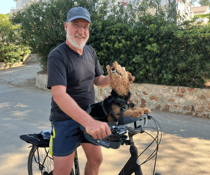 man on a bicycle with a dog