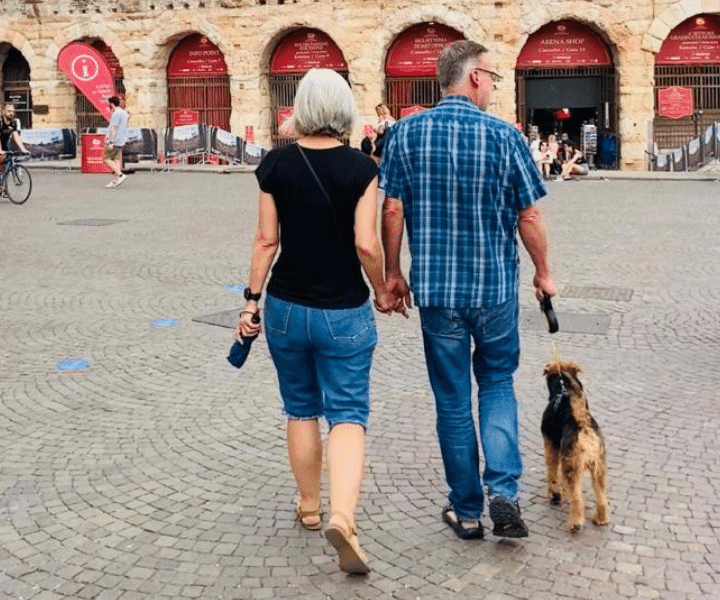 man and woman and dog walking