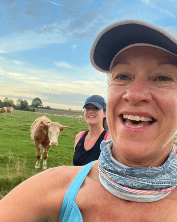 two ladies running and a cow