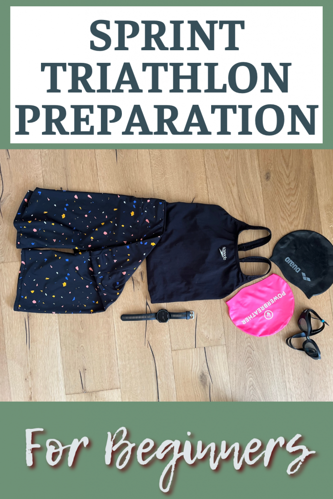 Sprint triathlon preparing swimming shorts, swim suit, caps, goggles and a sports watch all laying on a wooden floor #sprint-triathlon #women #fit-at-50 #run #swim #cycle